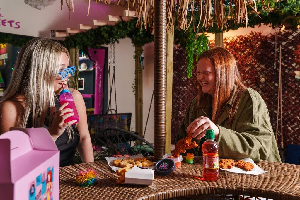 Two Girls Laughing Baddie Meal Outdoor Terrace — The Mad House Dean Street, Newcastle